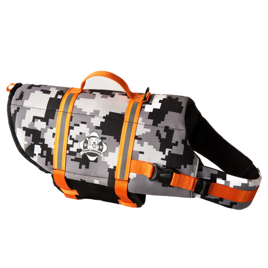 Black and grey digital camouflage dog life jacket with fluorescent orange reflective straps and top rescue handle. Paws Aboard logo on side of neoprene jacket centered between the straps.