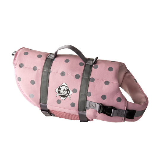Pink and grey polka dot dog life jacket with reflective straps and top rescue handle. Paws Aboard logo on side of neoprene jacket centered between the straps.
