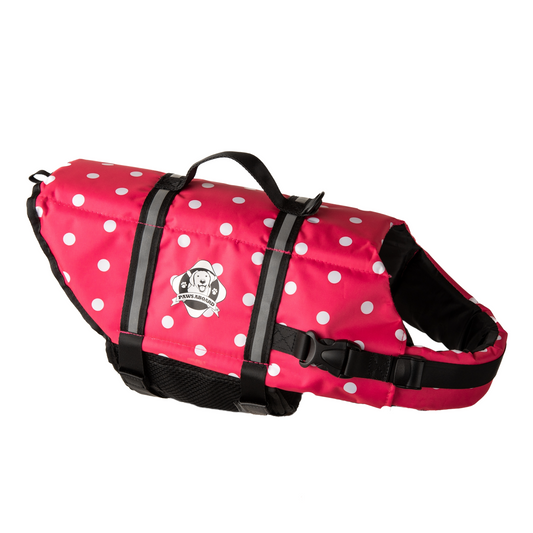 Pink and white polka dot dog life jacket with reflective straps and top rescue handle. Paws Aboard logo on side of nylon jacket centered between the straps.